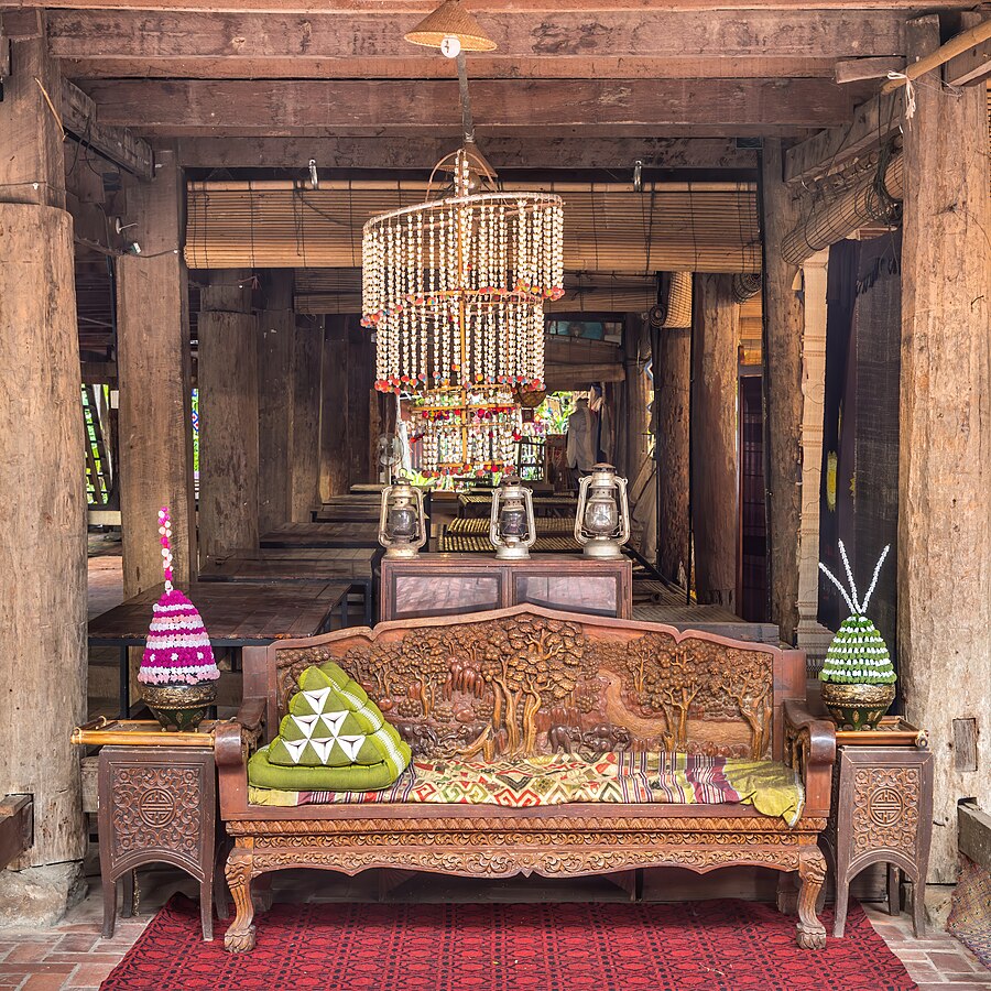 Carved wooden bench furniture and crafts at Heuan Chan heritage house in Luang Prabang Laos