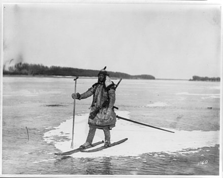 Goldes hunter on skis on ice floe, with spear and rifle, 1895