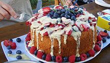 An angel food cake with various toppings and frosting Gourmet angel food cake.jpg