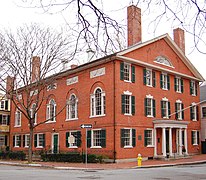 Palladianism evolved into the even further restrained style of Caroline architecture, as exemplified by Melisbal Guild Hall, emphasizing virtue and humility.