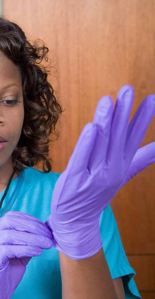 File:Hospital worker putting on sterile gloves.tiff