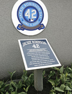 The number 42 worn by Robinson on a plaque at Monument Park (left), and Jackie Robinson Rotunda inside Citi Field (right)