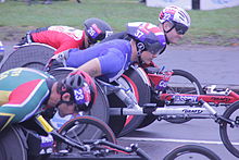 Elite wheelchair competitors at the start of the race: David Weir (37) 2nd, Josh Cassidy (22), Ernst van Dyk (23) 5th, Kota Hokinoue (26) 7th London Marathon 2015.jpg