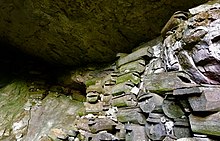 A Kankanaey burial cave in Sagada with coffins stacked-up to form a sky burial within a cave. Lumiang, Burial Cave.jpg