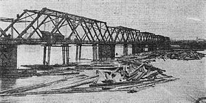 The second bridge in March 1908, when flooding upriver had caused a log jam to accumulate around it. The swing span is out of frame to the left in this view. Madison Street Bridge with log jam, March 1908 - Portland, Oregon.jpg