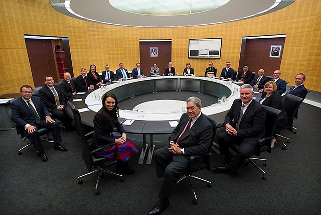 Pictured in 2017, the then-Prime Minister Jacinda Ardern (foreground, left of centre) chairs her first meeting of Cabinet, wherein government policy i