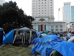 Tents within the protest camp of Occupy Oakland at Frank H. Ogawa Plaza on November 12, 2011. Oakland City Hall stands in the background. Occupy Oakland Nov 12 2011 PM 09.jpg