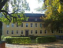 Manor complex with mansion, administrator's house, farm workers' house and farm yard and park with burial place and adjoining landscape area