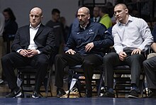 Head coach Cael Sanderson and assistant coaches look on during the wrestling match against Buffalo at Rec Hall in February 2019 Penn State Wrestling Coaches.jpg