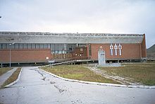 The community center in Pyramiden, complete with a statue of Vladimir Lenin Pyramiden Svalbard 2.jpg