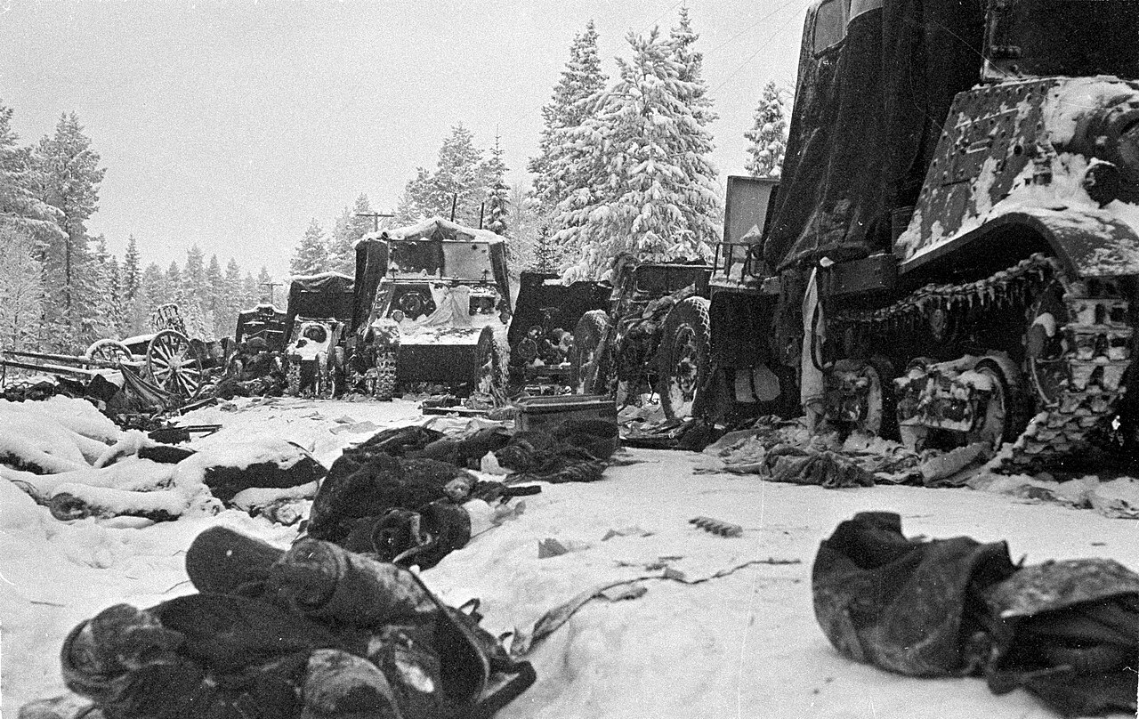 Fallen Soviet soldiers and their equipment litter the road and the ditch next to it after being encircled at the Battle of Raate Road