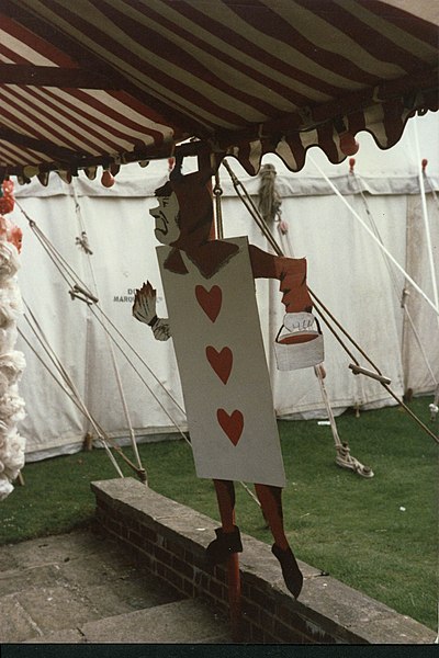 File:Red card man on covered steps between bar and dining marquees wye college commem ball 1985.jpg