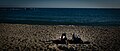 A couple relaxing on the beach in Barcelona.