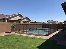 Newly installed removable mesh pool fence used to provide a protective barrier between children and the swimming pool Removable Mesh Pool Fence in Phoenix, AZ.jpg