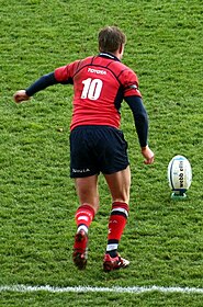 Ronan O'Gara playing for Munster in 2006 RonanOGaraKicking(cropped).jpg