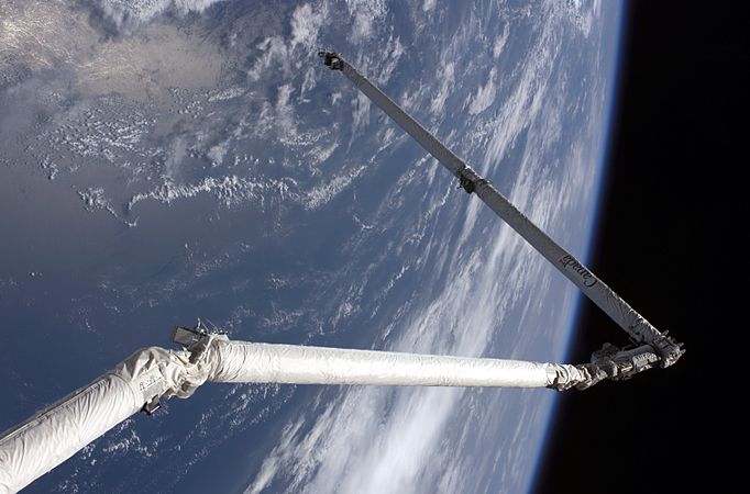 Shuttle Remote Manipulator System (RMS) holding OBSS boom on STS-114