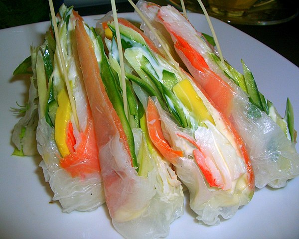 Example of a fusion dish: combination of smoked salmon wrapped in rice paper, with avocado, cucumber and crab sticks