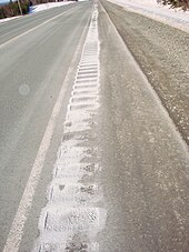 Deicing salt-filled and stained rumble strip. The rock salt has been "cemented" in place Salt Rumble Strip.JPG