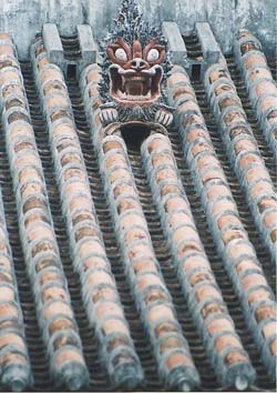 A shisa statue placed on a roof.