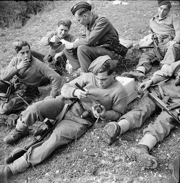 A battle patrol of the 1st Battalion, East Surrey Regiment rest after returning from enemy territory, 16 December 1943. They are armed with Thompson S