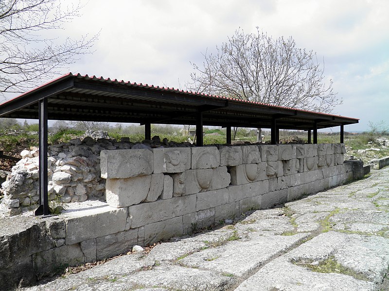 File:The east façade of the Roman Basilica, reuse of a frieze with representation of shields and cuirasses from Hellenistic times, Ancient Dion (7098478865).jpg