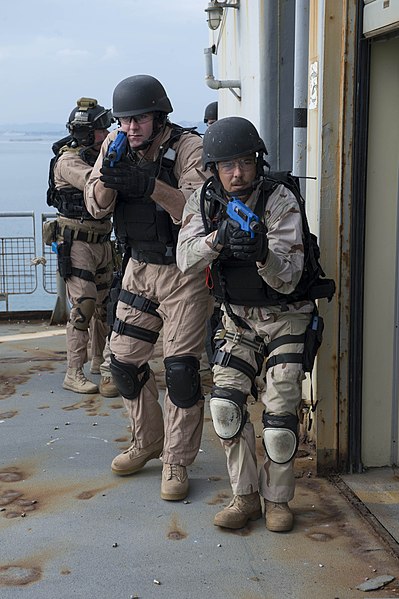 File:U.S. Navy Ensign Carson Talley, left, and Senior Chief Sonar Technician Brian Morgan, members of the boarding team with the guided missile destroyer USS Stout (DDG 55), conduct tactical team movement training 131216-N-UD469-238.jpg