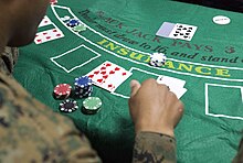 A game of blackjack where the dealer has a single face-down hole card USS San Antonio casino night 160310-M-KK554-046 (cropped).jpg
