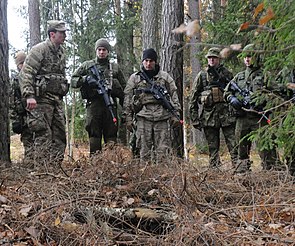 An instructor shows students the construction of a proper sub-surface hide-site during Phase 1 of RSLC's first overseas course in Lithuania, circa 2016 US Army RSLC-1.jpg