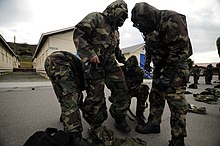 US Navy medical training students don JSLIST MOPP ensembles. US Navy 120114-N-GO179-007 Kandahar Role 3 Operational Medical Training Program students don J-LIST mission-oriented protective posture gear during.jpg