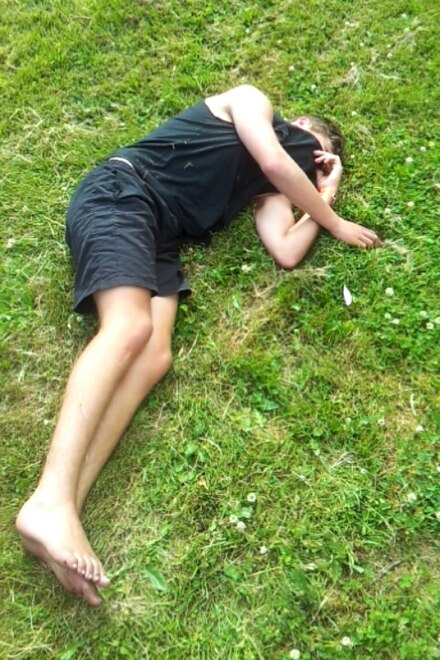A young man lying comatose after a binge drinking session
