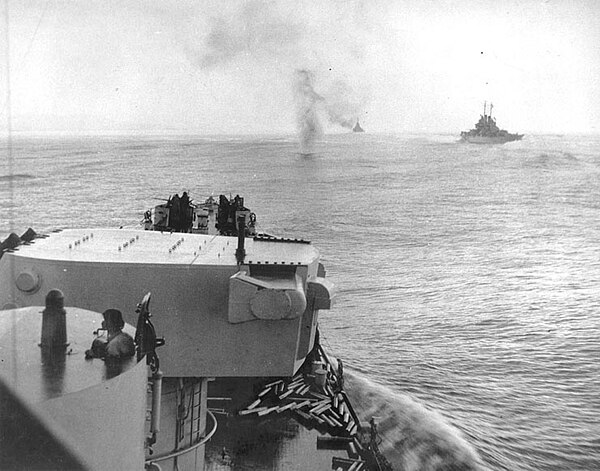 A Japanese plane plunges into the sea ahead of the light cruiser USS Columbia, as she steams in column with other cruisers during the attack on Bougai