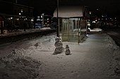 Two small snowmen on a train station in Täby, Sweden