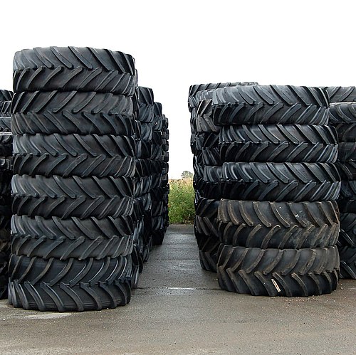 Tractor tires have substantial ribs and voids for traction in soft terrain.