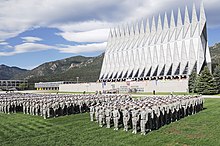 More than 1,300 basic cadets salute during the ceremonial Oath of Office formation on 26 June 2009. The Cadet Chapel is in the background. Air Force Academy Oath of Office.jpg