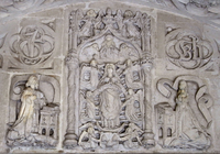 Relief sculpture in the 1517 Greenway Porch, St Peter's Church, Tiverton, showing the Apotheosis of the Virgin with the pre-Reformation arms and supporters of the Drapers Company, below ApotheosisOfTheVirgin 1517 GreenwayPorch StPetersChurch Tiverton.PNG