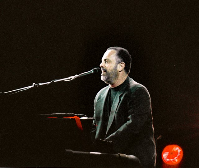 A photo of Billy Joel playing the piano