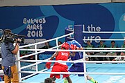 Deutsch: Boxen bei den Olympischen Jugendspielen 2018 Tag 12, 18. Oktober 2018 - Finale Fliegengewicht Mädchen – Martina La Piana (Italien, blau) schlägt Adijat Gbadamosi (Nigeria, rot) 5-0; Ringrichter ist James Beckles (Trinidad und Tobago). English: Boxing at the 2018 Summer Youth Olympics on 18 October 2018 – Girl's flyweight Gold Medal Bout - Martina La Piana (Italy, blue) beats Adijat Gbadamosi (Nigeria, red) 5-0; Referee is James Beckles (Trinidad and Tobago). Español: Boxeo en los Juegos Olímpicos Juveniles de Verano de 2018 en 18 de octubre de 2018 - Combate a medalla de oro de peso mosca para mujeres: Martina La Piana (Italia, azul) le gana a Adijat Gbadamosi (Nigeria, roja) 5-0; El árbitro es James Beckles (Trinidad y Tobago).