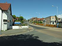 De voet van Bray Hill, gezien tegen de rijrichting van de Isle of Man TT in. Dit is de kruising van Tromode Road (links), de A2 Bray Hill (vooruit), Stoney Road (rechts) en de A2 Quarterbridge Road (achter)