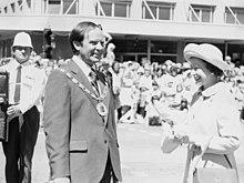 The Queen with the Brian Elwood, Mayor of Palmerston North, New Zealand, during a walkabout in The Square, 26 February 1977 Brian Elwood and the Queen 1977.jpg