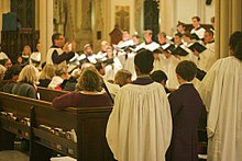 Canon Lawrence Tremsky (Director of Music) conducting the cathedral choirs in formal garb Cathedral Choirs.jpg