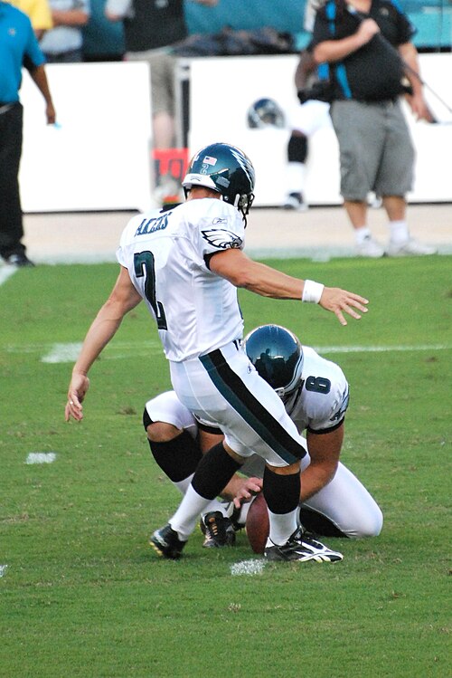 Akers attempting a field goal in August 2009.