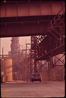 The entrance to the Kaiser Aluminum plant under the bridge in 1972 ENTRANCE TO THE KAISER ALUMINUM PLANT BENEATH THE MISSISSIPPI RIVER BRIDGE. BECAUSE OF CORROSIVE FUMES FROM NEARBY... - NARA - 546085.jpg