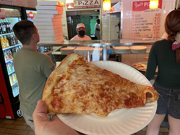 A slice of New York pizza, thin and crispy.