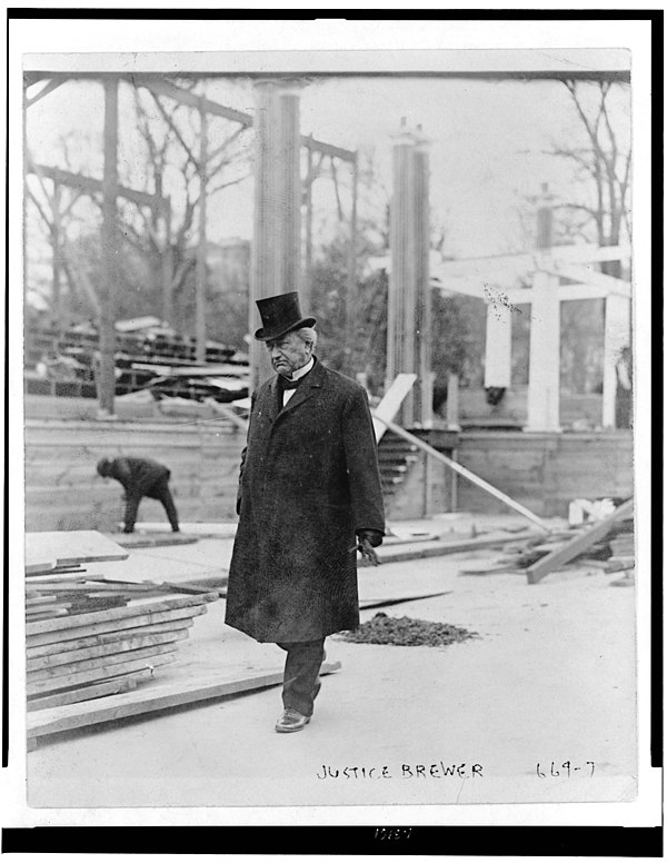 Brewer walks past a construction worker.