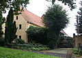 Residential stable house (without converted rear part) with wall section and gate as well as two remaining supports of the archway