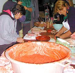 Women sewing sobrassada during the festival of the slaughter of pigs, Son Ferriol, Majorca.