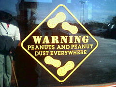 A warning sign for the presence of peanuts and peanut dust