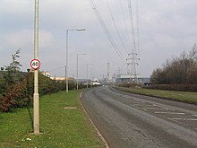 Phoenix Parkway with the power station in the distance Phoenix Parkway, Corby - geograph.org.uk - 378042.jpg