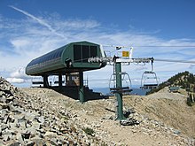 A 1988 Poma high speed quad, the Rainier Express lift, at Crystal Mountain, Washington Poma chairlift 2007.jpg