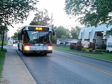 A Blue bus stops at North Creekside Apartments Razorback Transit Blue stopping at North Creekside Apartments.jpg